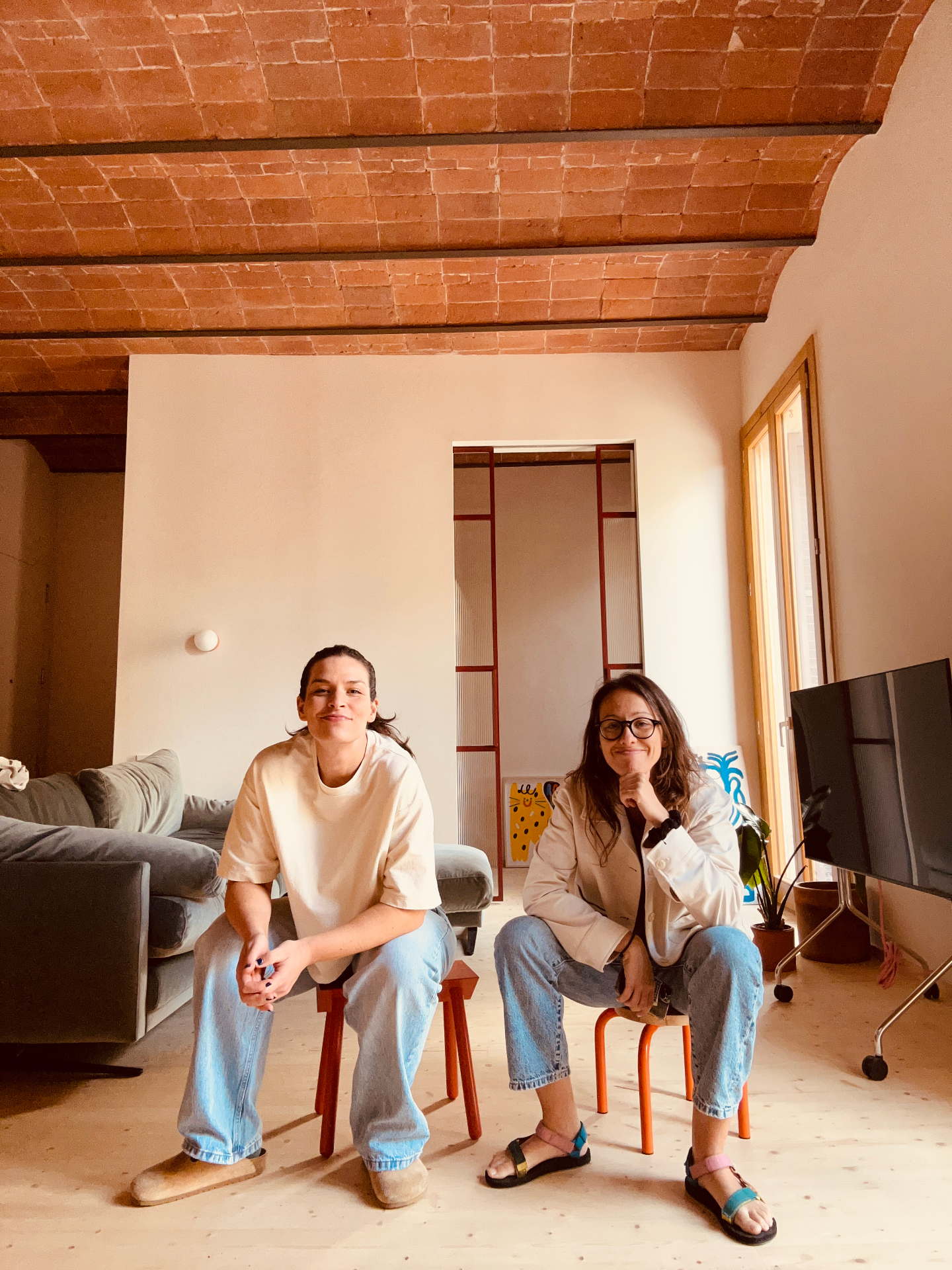 The Sunny Side Collective at home — Gemma and Bernadett seated under a terracotta vaulted ceiling
